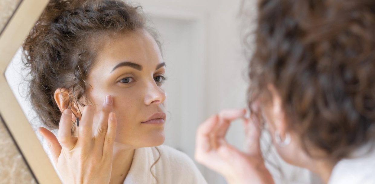 woman-looking-mirror-doing-beauty-face-routine-1-1